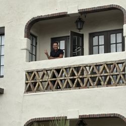 Michelle Cote, PA-C at Etoile Aesthetics SD - Dominic waving from the med spa balcony