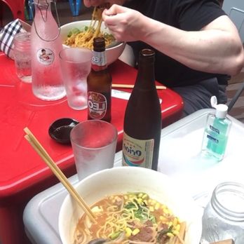 OKI Shoten - Currently during pandemic half off beers all day long and $2 off Appetizers, friend who hates soup is seen here face planting in bowl - Ramen Near Me - Washington, DC, District of Columbia