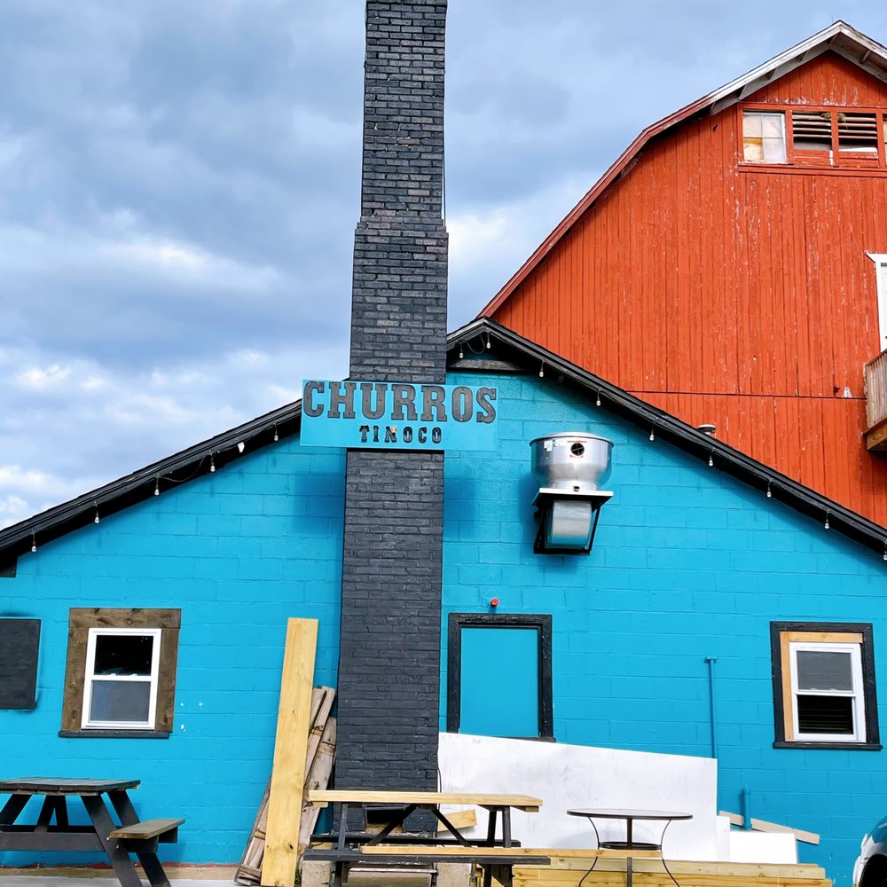 Churros Tinoco - Located towards the back. Nice picnic tables to sit outside and enjoy. I witnessed them cleaning  those tables up @ closing time - Desserts Near Me - East Dundee, Illinois