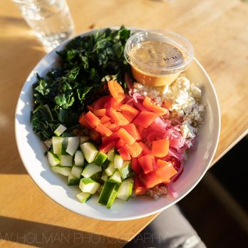WildFlour Cafe & Bakery - Signature Lunch Bowl: Quinoa, kale, cucumber, bell pepper, cherry tomato, pickled red onion, and feta with a garlic tahini sauce. - Juice Bars & Smoothies Near Me - Sitka, Alaska WildFlour Cafe & Bakery - Signature Lunch Bowl: Quinoa, kale, cucumber, bell pepper, cherry tomato, pickled red onion, and feta with a garlic tahini sauce. - Juice Bars & Smoothies Near Me - Sitka, Alaska