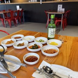 a table with bowls of food and utensils