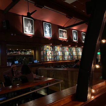 Belly Up Tavern - Interesting line up of vintage photos on the back wall along with another small bar to order drinks. - Bars Near Me - Solana Beach, California