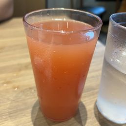 a glass of orange juice and a glass of water a glass of orange juice and a glass of water