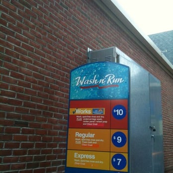 McLean Exxon - a blue and yellow sign on a brick wall - Gas Stations Near Me - McLean, Virginia