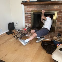 DelVal Wildlife Nuisance Control - Chris getting all up in the fireplace to dislodge the raccoon carcass.