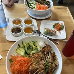 Chicken vermicelli bowl, pork vermicelli bowl and remains of two spring rolls. Chicken vermicelli bowl, pork vermicelli bowl and remains of two spring rolls.