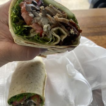 Wrap Happy - a hand holding a wrap of food - Wraps Near Me - Brunswick, Georgia Wrap Happy - a hand holding a wrap of food - Wraps Near Me - Brunswick, Georgia