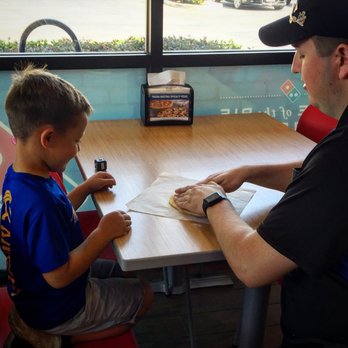 Domino's Pizza - a man and a boy sitting at a table - Pizza Near Me - Ripon, California