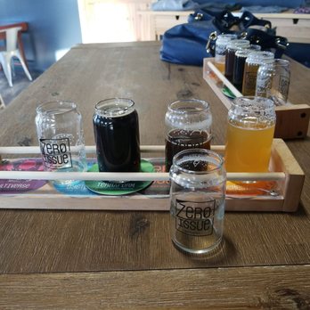 Zero Issue Brewing - a tray of beers and glasses on a table - Breweries Near Me - Calgary, Alberta Zero Issue Brewing - a tray of beers and glasses on a table - Breweries Near Me - Calgary, Alberta