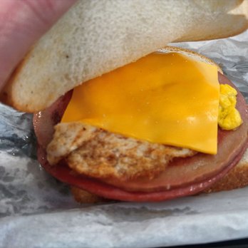 double kwik - a hand holding a sandwich with cheese and meat - Convenience Stores Near Me - Nicholasville, Kentucky