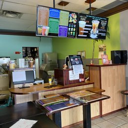 a small restaurant with tables and televisions a small restaurant with tables and televisions