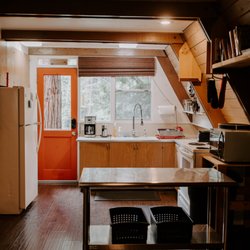 Idyllcreek A-Frame Vacation Cabin - Refrigerator, microwave, and coffeepot are all ready for use.