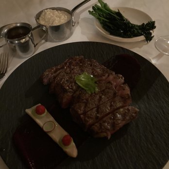 The Grill Room - Ribeye, grits, and (not so) charred broccolini - New American Near Me - New Orleans, Louisiana