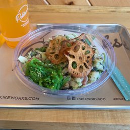 Poke Noodle bowl, topped with lotus chips with Mandarin orange drink Poke Noodle bowl, topped with lotus chips with Mandarin orange drink