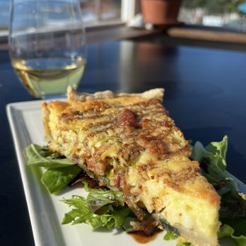 Madeline's on Moonstone - Wine & a savory tart filled with leeks, bacon, cheese, eggs, & drizzled with balsamic glaze. - Wine Tasting Room Near Me - Cambria, California Madeline's on Moonstone - Wine & a savory tart filled with leeks, bacon, cheese, eggs, & drizzled with balsamic glaze. - Wine Tasting Room Near Me - Cambria, California