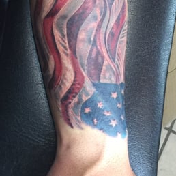 Realistic American Flag created by tattoo artist David Jesse Rios at Tiki Tattoos Realistic American Flag created by tattoo artist David Jesse Rios at Tiki Tattoos