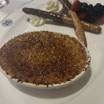 NYY Steak - Crème Brûlée served with chocolate covered pretzels, berries and whipped cream - Steakhouses Near Me - Coconut Creek, Florida