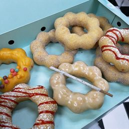 Mango, Ube Churro, Raspberry Funnel Cake, Glazed - they added a couple extra since we were the last customers of the night :) Mango, Ube Churro, Raspberry Funnel Cake, Glazed - they added a couple extra since we were the last customers of the night :)