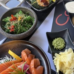 Salmon sashimi, seaweed salad, and baked mussels