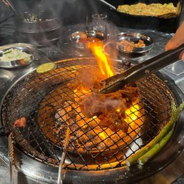 Cooking the meat at the grill at our table to our desired level of doneness.