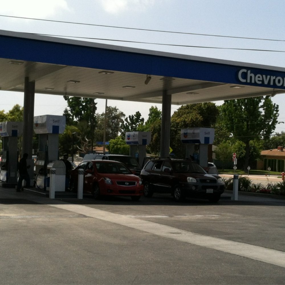 a gas station with cars parked in front of it