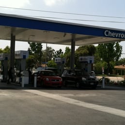 a gas station with cars parked in front of it