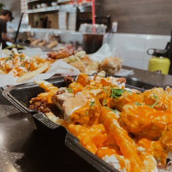 Fire Wings - two trays of food on a counter - Chicken Wings Near Me - Reno, Nevada Fire Wings - two trays of food on a counter - Chicken Wings Near Me - Reno, Nevada