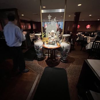 Hsu's Atlanta - a man standing in a dimly lit restaurant - Chinese Near Me - Atlanta, Georgia