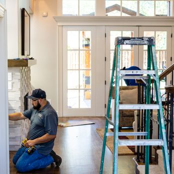 Amco Restoration - a man working on a staircase - General Contractors Near Me - Rogers, Arkansas