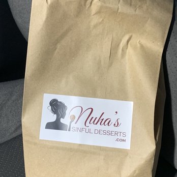 Nuha's Sinful Desserts - a brown paper bag with a sticker on it - Desserts Near Me - Austin, Texas