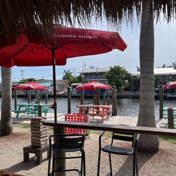 Low Key Tiki - tables and chairs with umbrellas - Seafood Near Me - Saint James City, Florida Low Key Tiki - tables and chairs with umbrellas - Seafood Near Me - Saint James City, Florida