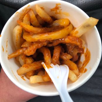 Fast Eddie's - a hand holding a bowl of fries - Fast Food Near Me - London, Ontario