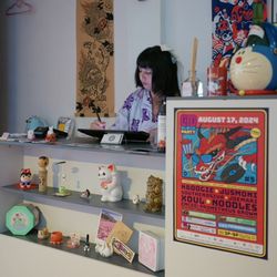 Shop owner, Mandy, working on new designs behind counter during Hai! Japantown