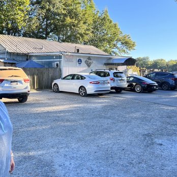 Capitol Oyster Bar - a woman standing in front of a row of parked cars - New American Near Me - Montgomery, Alabama Capitol Oyster Bar - a woman standing in front of a row of parked cars - New American Near Me - Montgomery, Alabama