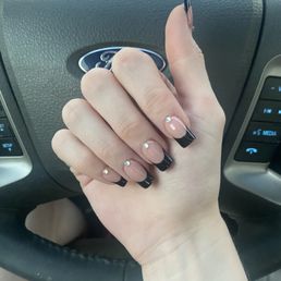 Black french tip over natural with rainbow diamond charms, tapered short square nail.