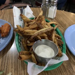 a plate of fries and a bowl of dip