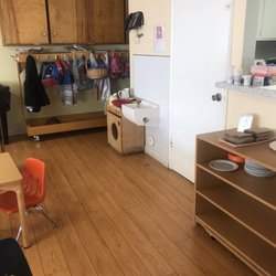 Monty's Montessori Academy of Ontario - Practical Life dish washing station and cupboard with real plates and forks.