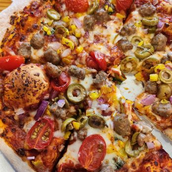 Pizza by Design 2 - My spicy red sauce based pizza with Italian sausage, basil, green olives, and tomato. Yummy! - Pizza Near Me - Abilene, Texas Pizza by Design 2 - My spicy red sauce based pizza with Italian sausage, basil, green olives, and tomato. Yummy! - Pizza Near Me - Abilene, Texas