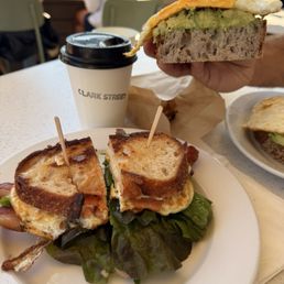 Breakfast sandwich and avocado toast with fried egg Breakfast sandwich and avocado toast with fried egg