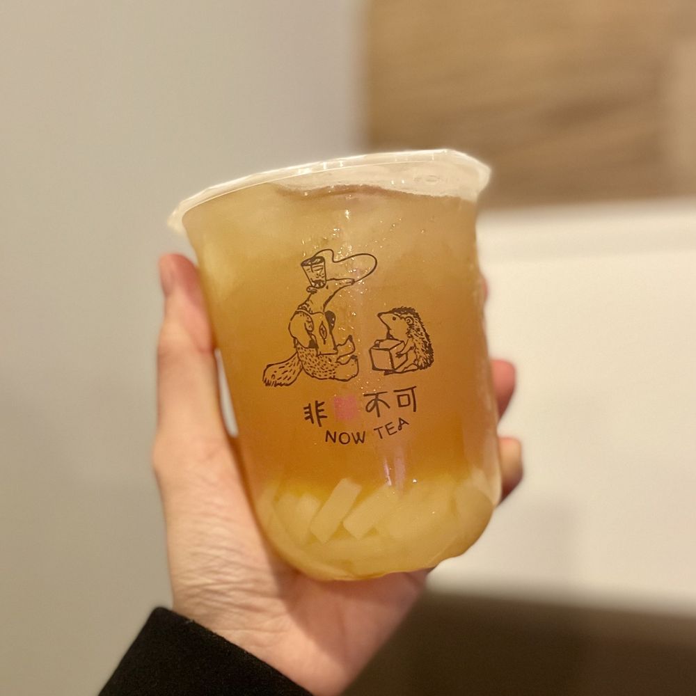 a person holding a cup of tea a person holding a cup of tea