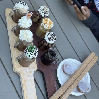 Grandpa's Cellar - Hot chocolate (tan board), Grandpa's Classics (brown board), and Apple Spice Churros with Apple sauce. - Bakeries Near Me - Camino, California