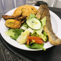 Under African Skies - Fish, Jollof rice, fried plantain, vegetables salad
