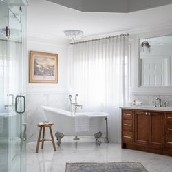 DuVäl Design - Fully renovated owner's bathroom with barrier free shower, custom cabinetry, and heated flooring.