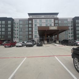 Exterior outside entrance of Sandman Signature Dallas-Las Colinas Hotel & Suites - Hotel store front. December 2025. - Irving, Texas Exterior outside entrance of Sandman Signature Dallas-Las Colinas Hotel & Suites - Hotel store front. December 2025. - Irving, Texas