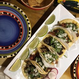 a variety of tacos on a plate a variety of tacos on a plate