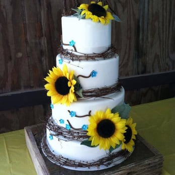 Laura Marie's - a three tiered cake with sunflowers - Bakeries Near Me Laura Marie's - a three tiered cake with sunflowers - Bakeries Near Me