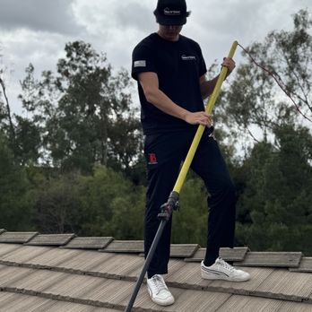 Wave Cleaning Services - Technician cleaning solar panels - Window Washing Near Me Wave Cleaning Services - Technician cleaning solar panels - Window Washing Near Me
