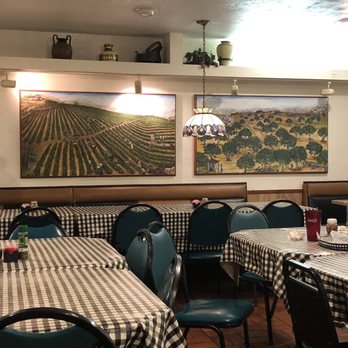 ABC Pizza Restaurant - Center tables with Mediterranean themed artwork adorning the walls. - Pizza Near Me - Chiefland, Florida