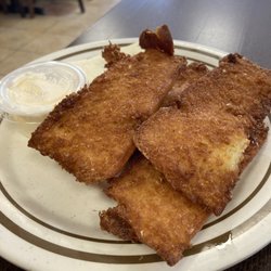 Nuriaâs Restaurant - Fried tamales. No filling - just fried masa. With mayonnaise and a slab of cheese.