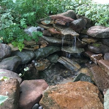 Visionary Landscaping - a water feature in a garden - Landscaping Near Me